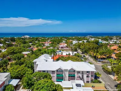 an aerial view of a city with a building and the ocean at Bright & Modern Apartment in Puerto Plata, Secure, and Central! in San Felipe de Puerto Plata