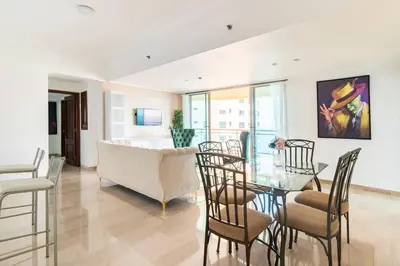 a living room with a glass table and chairs at Gateway For You And Your Loves Ones I Sleeps 6 in Santo Domingo