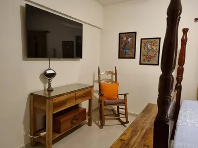 a bedroom with a desk and a tv and a chair at Your Little Paradise - Juan Dolio in Juan Dolio