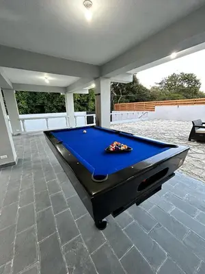 a pool table in the middle of a room at Villa Mónaco Jarabacoa RD in Jarabacoa