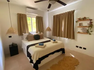 a bedroom with two beds and a ceiling fan at Xarraca, excepcional apartamento in Bayahibe