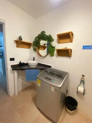 a bathroom with a sink and a trash can at Xarraca, excepcional apartamento in Bayahibe