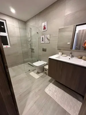 a bathroom with a toilet and a sink and a shower at LUXURY CONDO Cana Bay 1 CLUB BEACH in Punta Cana