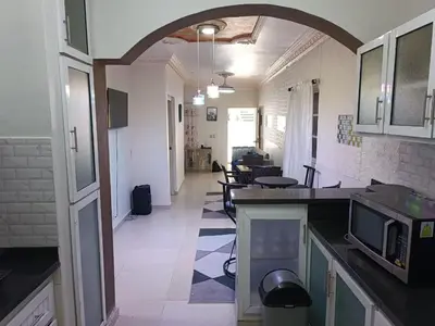 a kitchen with an archway leading into a room at Apartamento Vista Sur in Baní