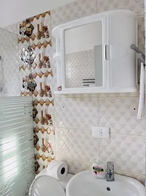 a bathroom with a sink and a toilet and a mirror at Complejo girasol in Santo Domingo