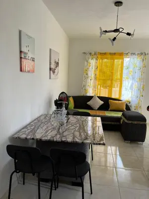 a living room with a couch and a table at RG Sol 1 in Pantoja