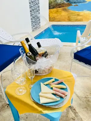 a table with a plate of cheese and bottles of wine at RG Sol 1 in Pantoja