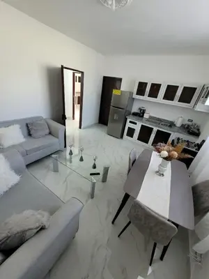 a living room with a couch and a table at Departamento Luna en Santo Domingo in Santo Domingo