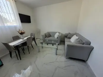 a living room with a couch and a table at Departamento Luna en Santo Domingo in Santo Domingo