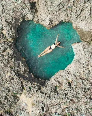 a person swimming in a heart shaped body of water at Caribbean Star - Estrella Dominicus Bayahibe in Bayahibe