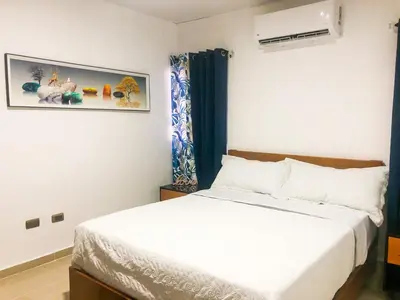 a bedroom with a bed and a picture on the wall at Ocean View Apart. In Down town in San Felipe de Puerto Plata