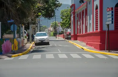 a white car parked on the side of a street at Ocean View Apart. In Down town in San Felipe de Puerto Plata