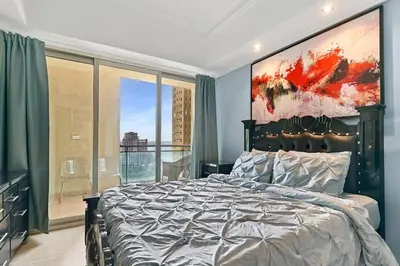 a bedroom with a large bed and a large window at Luxurious Ocean View Suite in Santo Domingo