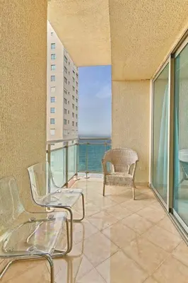 a balcony with chairs and a view of the ocean at Luxurious Ocean View Suite in Santo Domingo