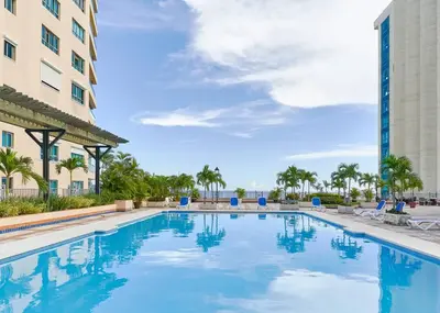 a large swimming pool in front of a building at Luxurious Ocean View Suite in Santo Domingo