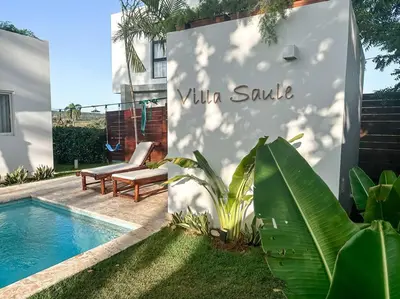 a sign for a villa suite next to a swimming pool at Villa Saule in Bombita