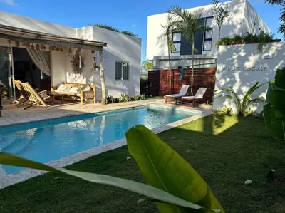 a backyard with a swimming pool and a house at Villa Saule in Bombita