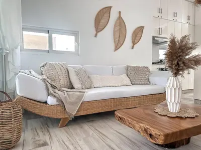 a living room with a white couch and a table at Villa Saule in Bombita