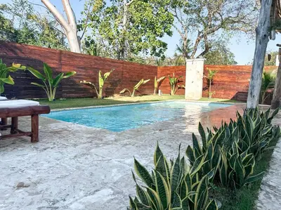 a swimming pool in a backyard with a wooden fence at Villa Saule in Bombita