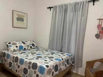 a bedroom with a bed and a window at Casa Canephora in Las Galeras