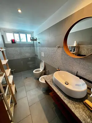 a bathroom with a sink and a toilet and a mirror at Apartment in Estrella, Dominicus-Bayahibe in La Laguna