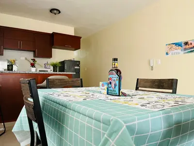 a bottle of alcohol sitting on a table in a kitchen at Casa Bonita Pimentel in Pimentel