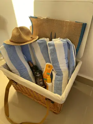 a basket with towels and a hat in a room at Bridget Place in Bayahibe