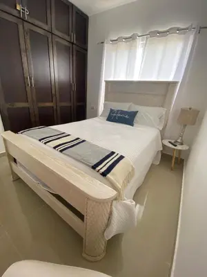 a bedroom with a large bed with a window at Bridget Place in Bayahibe