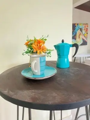 a table with two vases and a vase with flowers at LA CASA DE MAMA LUZ in San Felipe de Puerto Plata
