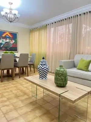a living room with a couch and a table at LA CASA DE MAMA LUZ in San Felipe de Puerto Plata
