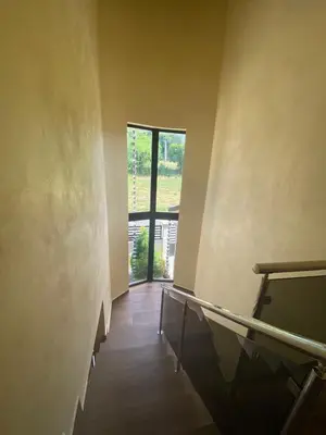 an empty room with a hallway with a glass door at VillaLunaCaridad in Jarabacoa