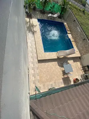 an overhead view of a swimming pool with a chair at VillaLunaCaridad in Jarabacoa