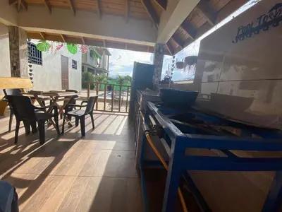 a kitchen with a stove and a table with chairs at VillaLunaCaridad in Jarabacoa