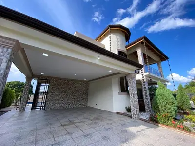 a house with a patio in front of it at VillaLunaCaridad in Jarabacoa
