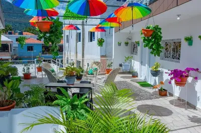 a patio with colorful umbrellas hanging from the ceiling at Royal Terrace V (Duque) in San Felipe de Puerto Plata