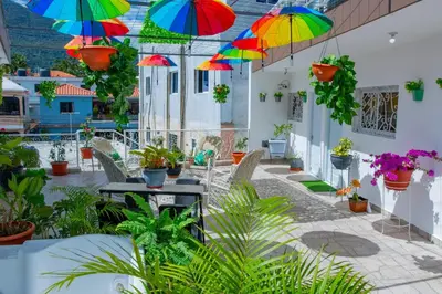 a patio with colorful umbrellas hanging from the ceiling at Royal Terrace V (Duque) in San Felipe de Puerto Plata