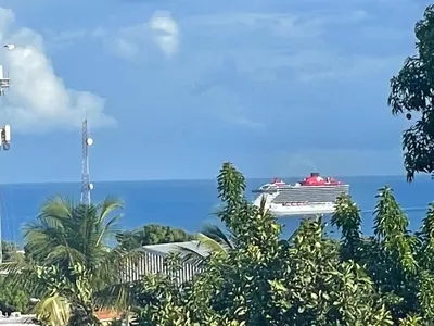 a cruise ship in the ocean with trees at Royal Terrace V (Duque) in San Felipe de Puerto Plata