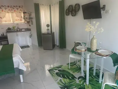 a living room with a table and a kitchen at Royal Terrace IV (King) in San Felipe de Puerto Plata