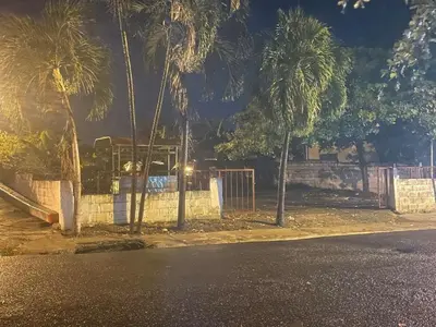 a street with palm trees and a playground at night at Royal Terrace III (Prince) in San Felipe de Puerto Plata