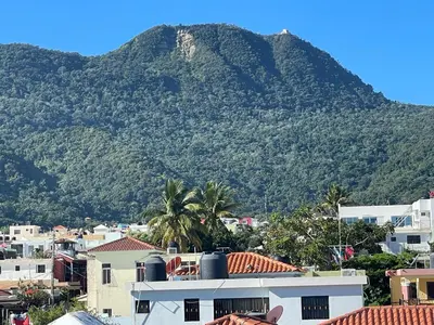 a mountain in the background of a city with houses at Royal Terrace III (Prince) in San Felipe de Puerto Plata