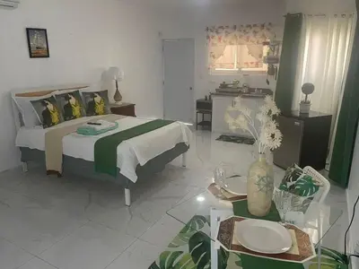 a bedroom with a bed and a table in a room at Royal Terrace I (Queen ) in San Felipe de Puerto Plata